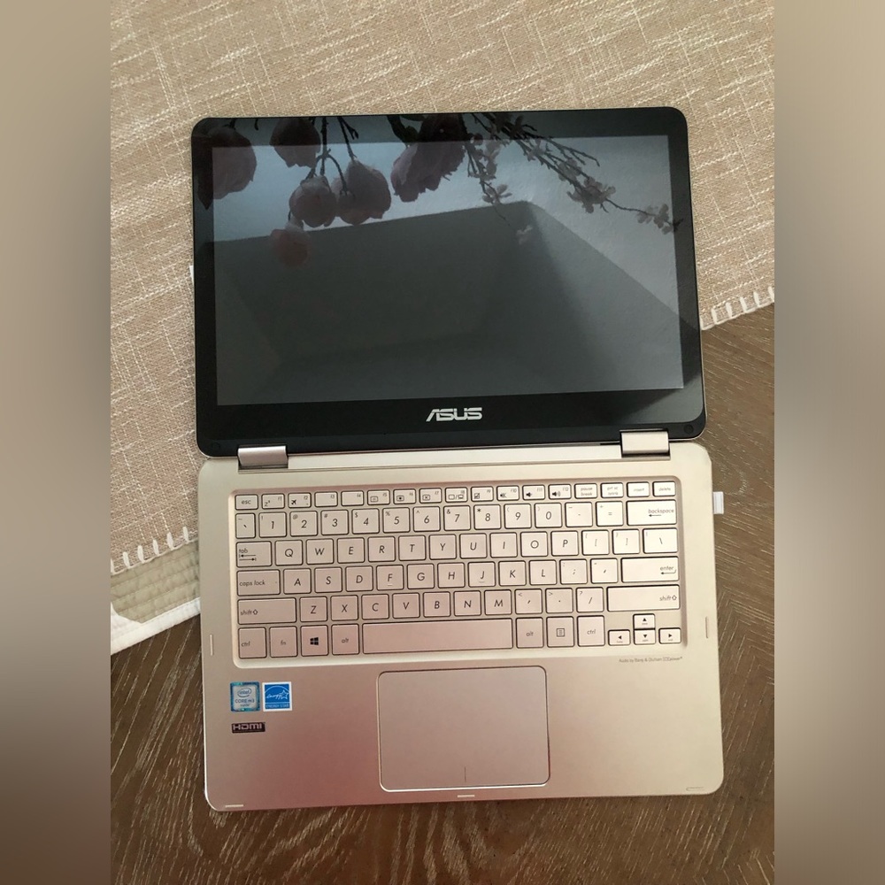 ASUS Metallic Silver Convertible Laptop with a wireless mouse and a charger.
